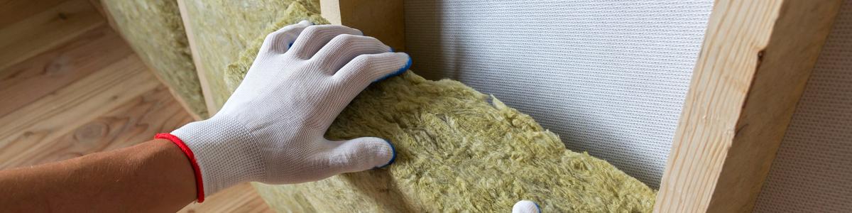 worker-hands-insulating-rock-wool-wooden-frame